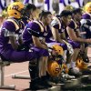 Players watch as their season nears an end in the fourth quarter Friday night against Hanford High School.